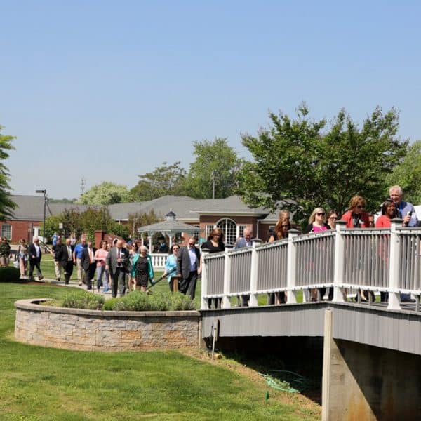 people walking over a bridge